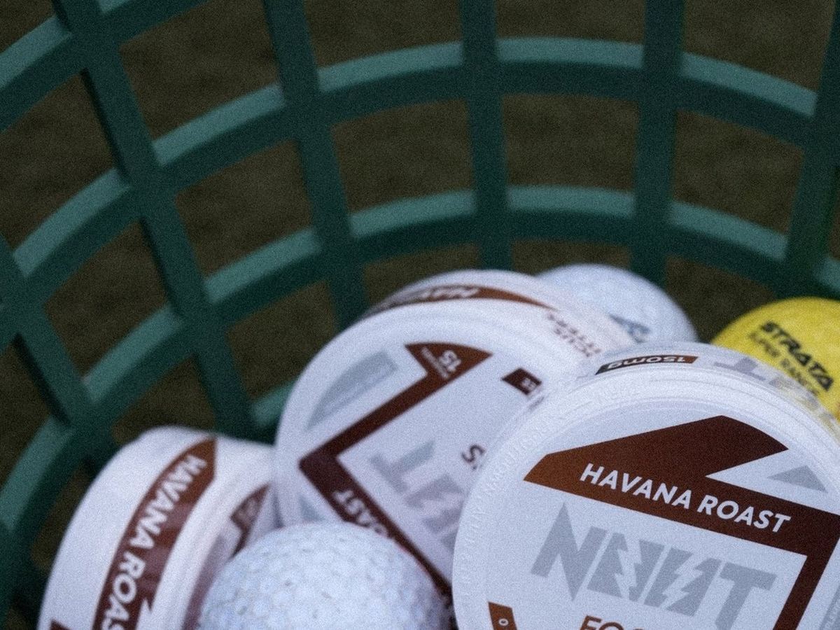 Havana Roast tins in a basket of golf balls